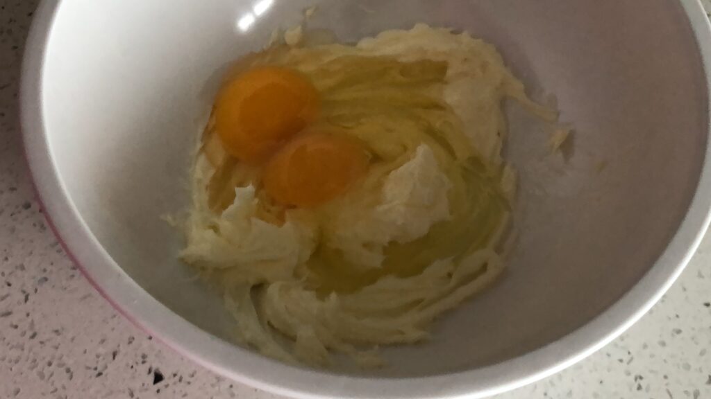 Add the eggs to your lemon cream cheese cookie batter