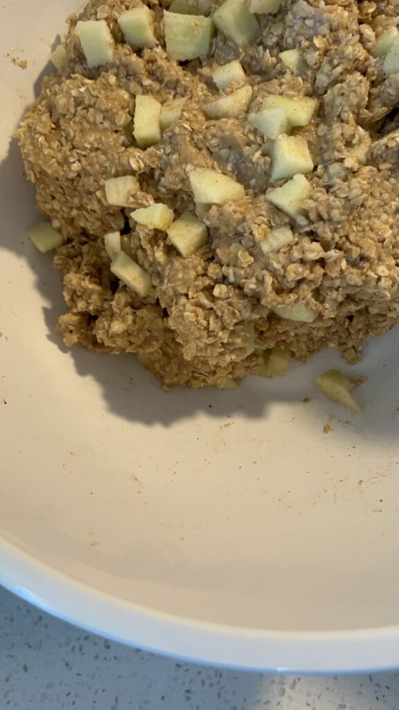 Adding apples to the oatmeal mixture